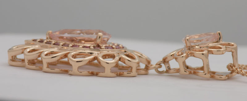 Rose gold morganite pendant with pink tourmaline accent stones.