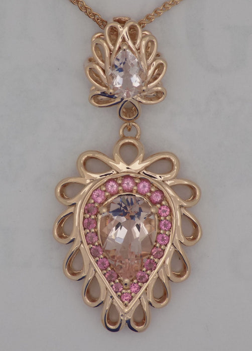 Rose gold morganite pendant with pink tourmaline accent stones.