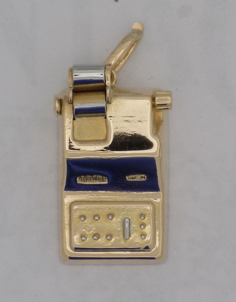 Yellow gold adding machine charm.