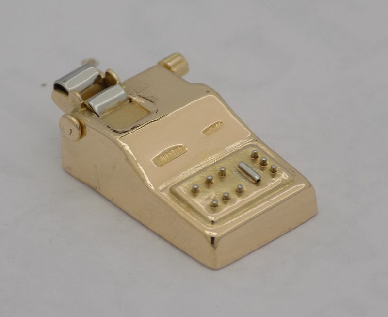 Yellow gold adding machine charm.
