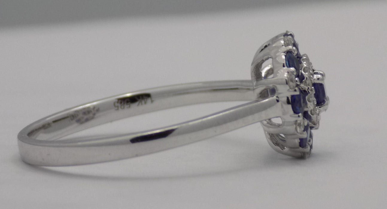 White gold round blue sapphire and diamond cluster ring.