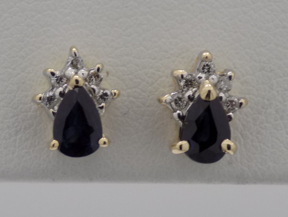 14 karat yellow gold pear shaped sapphire earrings with crown trim of diamonds.