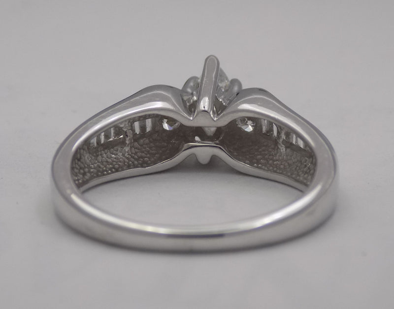 White Gold marquise center diamond with baguette side diamonds.