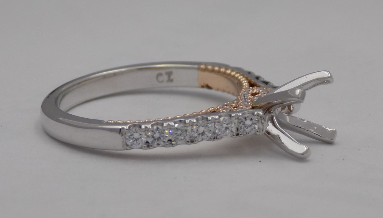 14 karat two-tone, white and rose gold diamond semi-mount engagement ring with infinity design, looking at side of shank.