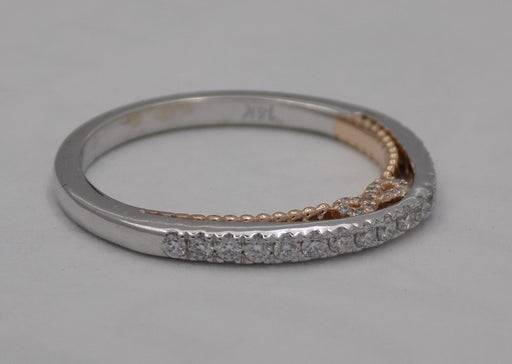 14 karat two-tone, white and rose gold diamond wedding band with infinity design, side view.