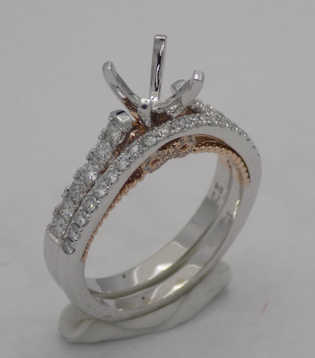 14 karat two-tone, white and rose gold diamond semi mount engagement ring with infinity design and matching wedding band (sold separately), shown together, angled top view.