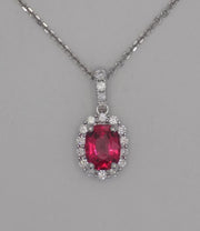 18 karat white gold natural spinel in diamond halo pendant.