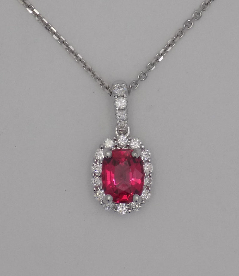 18 karat white gold natural spinel in diamond halo pendant.