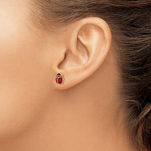 Model wearing 14 karat yellow gold ladybug stud earrings 
