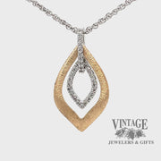Revolving video of 14 karat two tone diamond leaf shape necklace