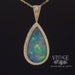 Revolving video of 14 karat yellow gold 9.63ct Pear shape opal with diamonds pendant