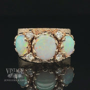 Revolving video of 14 karat yellow gold three stone crystal opal and diamond ring