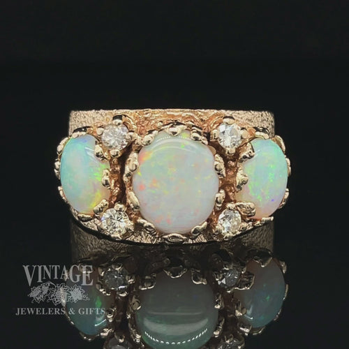 Revolving video of 14 karat yellow gold three stone crystal opal and diamond ring