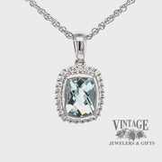 Revolving video of 14 karat white gold 1.02ct aquamarine diamond halo pendant