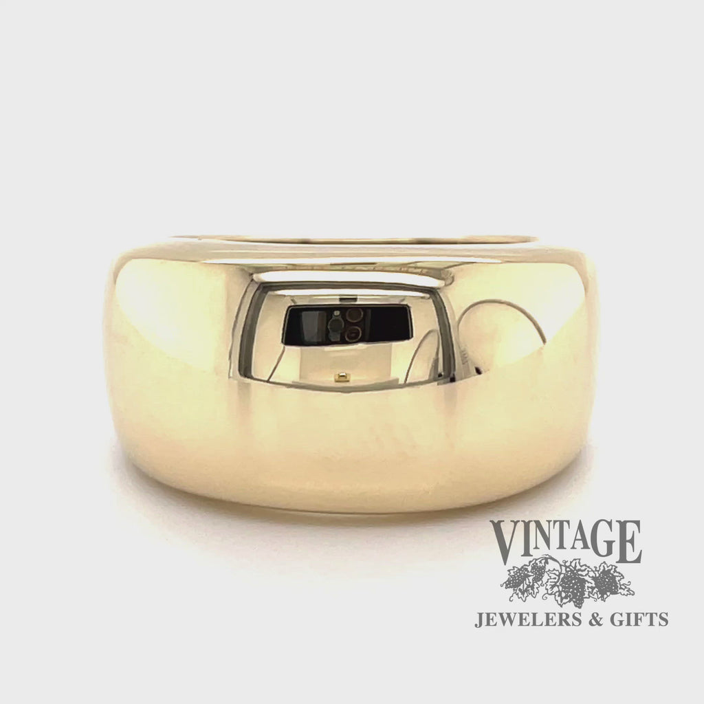 Revolving video of 14 karat yellow gold wide domed and tapered band