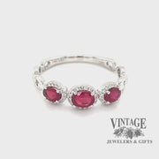 Revolving video of 14 karat white gold oval ruby with diamond halo ring