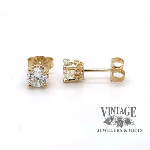 Revolving 360 degree video of .90 cwt. round diamond scroll design studs in14k yellow gold.