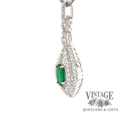 18 karat white gold natural emerald with diamond halo pendant, side view