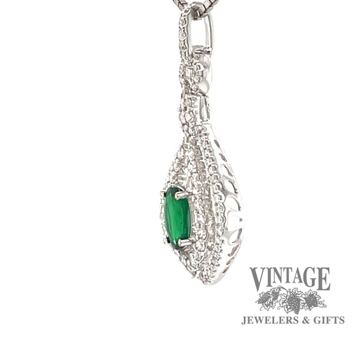 18 karat white gold natural emerald with diamond halo pendant, side view