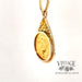 14 karat yellow gold estate state of Alaska 1/10 oz commemorative coin pendant, angled view
