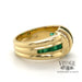 18 karat yellow gold emerald and diamond channel set band ring, side view