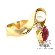 18 karat yellow gold pink tourmaline pearl and diamond bypass ring, angled view