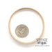 14 karat yellow gold floral solid bangle bracelet, side view shown with quarter for size reference
