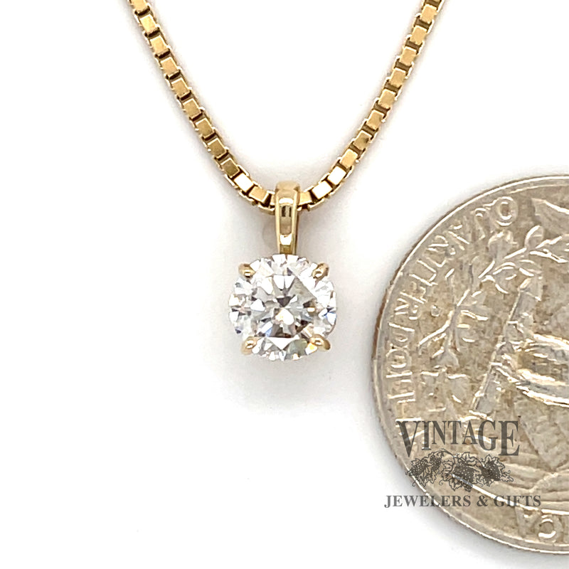 1.12 carat round natural diamond 14ky gold pendant next to quarter for scale