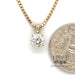 1.12 carat round natural diamond 14ky gold pendant next to quarter for scale