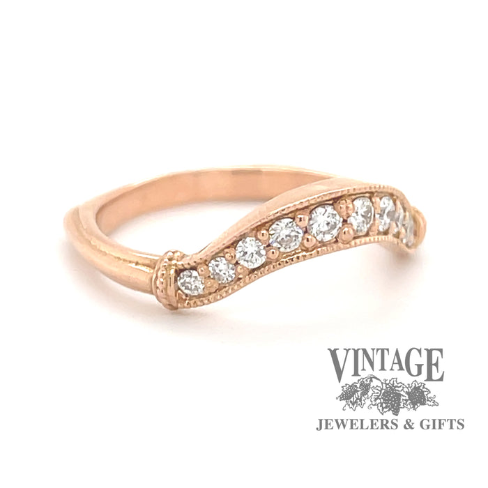 14K rose gold curved diamond wedding band, angled front view.