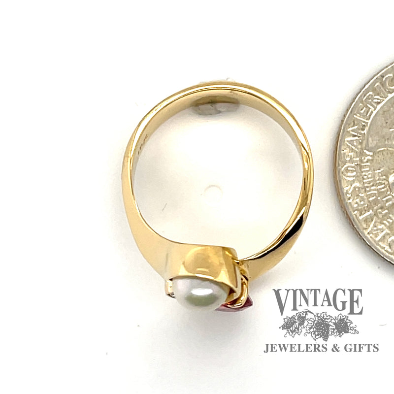 18 karat yellow gold pink tourmaline pearl and diamond bypass ring, side view through finger, shown next to quarter for size reference
