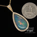 14 karat yellow gold 9.63ct Pear shape opal with diamonds pendant, shown with quarter for size reference