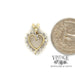 10 karat yellow gold heart shaped diamond pendant, shown with quarter for size reference