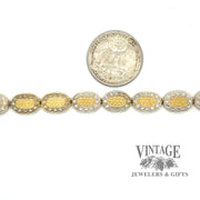 Two tone oval link embossed 14k gold 7.5" bracelet with quarter for scale