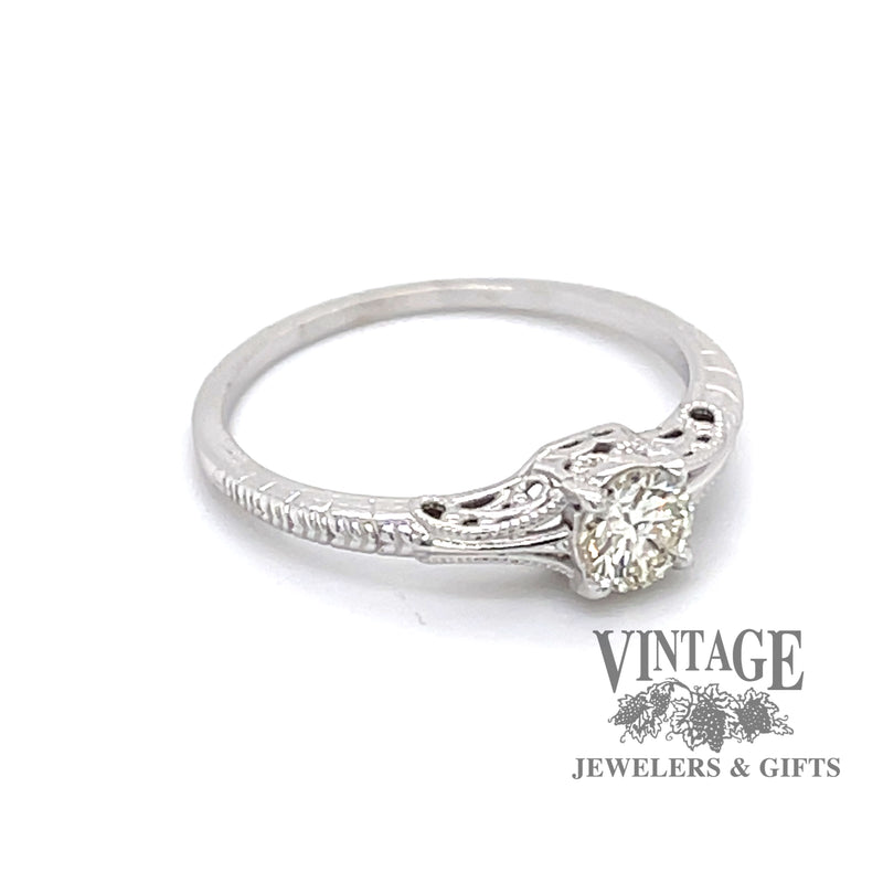 Edwardian inspired solitaire ring design is set with a sparkling .36 carat round H color, VS1 clarity, natural diamond in 14 karat white gold, agled front/side view