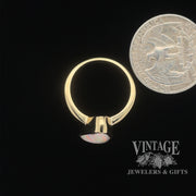 Natural white opal in 14ky gold ring quarter for scale