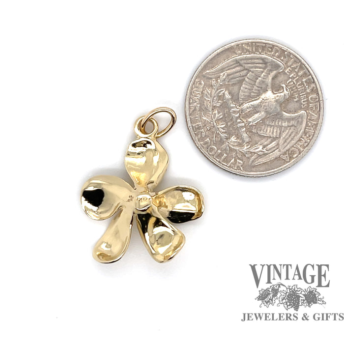 14 karat yellow gold diamond flower pendant, back, shown with quarter for size reference