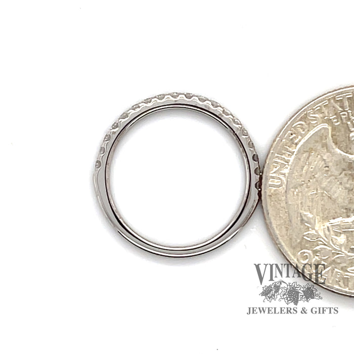 14 karat white gold .20ctw Diamond band ring, side  view through finger with quarter for size perspective