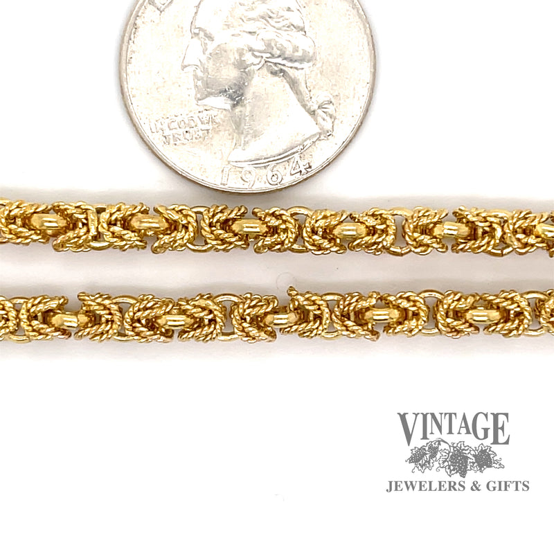 18 karat yellow gold Byzantine chain next to quarter for size reference