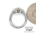 Platinum 1.28ctw round and pear-shape 3-diamond ring, side through ring, shown with quarter for size reference