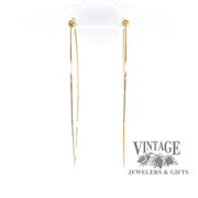 Large 14K gold teardrop shaped hoop earrings from front