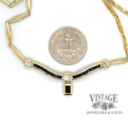 Sapphire and diamond 18 karat yellow gold choker necklace, next to quarter for scale