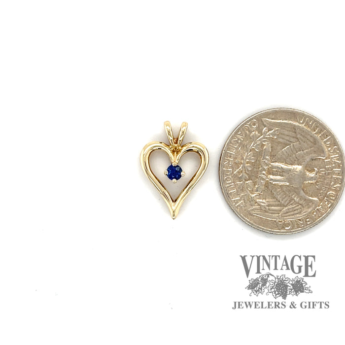 Heart shaped 14ky gold and sapphire pendant quarter for scale