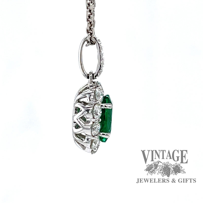Emerald and diamond 18k white gold halo pendant.