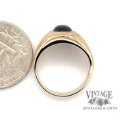 14 karat yellow gold Black star sapphire florentine ring, side view through finger, shown with quarter for size reference