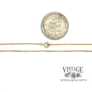 14 karat yellow gold round open link diamond cut cable chain shown with quarter for size reference
