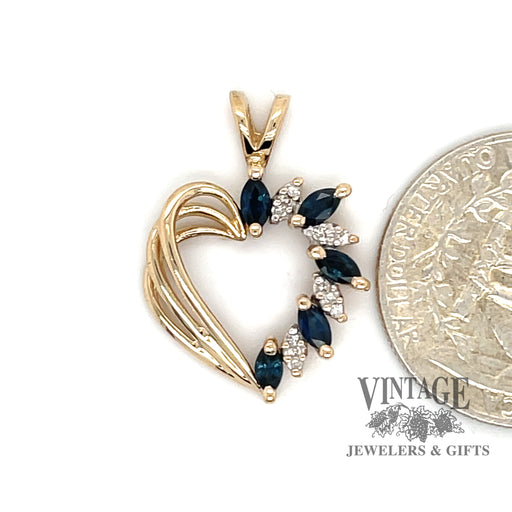 14 karat yellow gold Sapphire and diamond heart pendant, shown with quarter for size reference