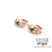 oblique view of emerald with diamond accent earrings