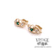 oblique view of emerald with diamond accent earrings