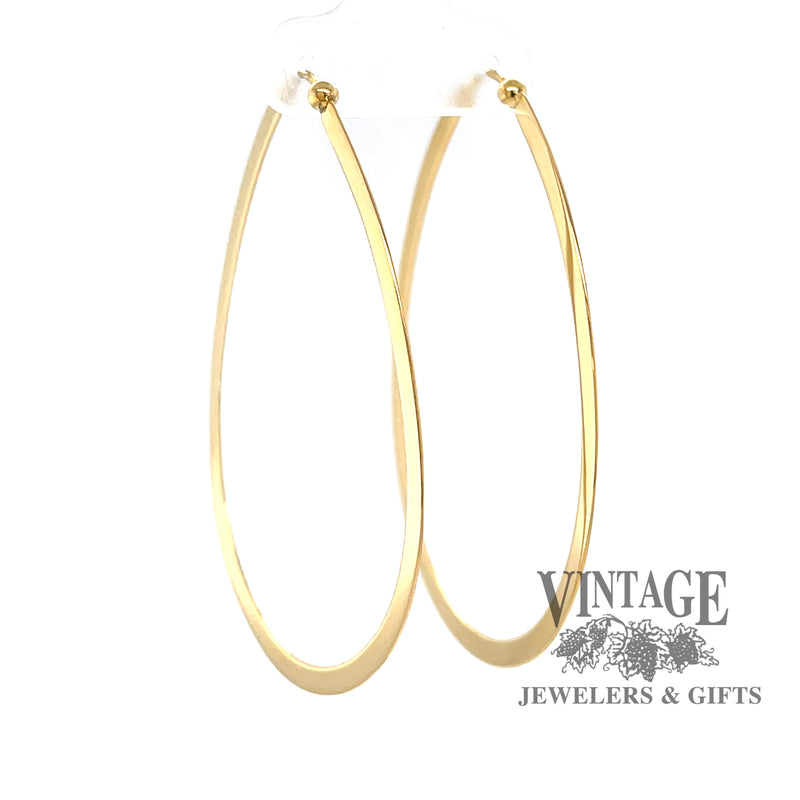 Large flat 14K gold teardrop shaped hoops from angle